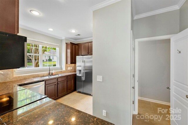 448 River Park Rd, Belmont, NC 28012 - kitchen with appliances with stainless steel finishes, crown molding, light tile patterned floors, decorative backsplash, and recessed lighting