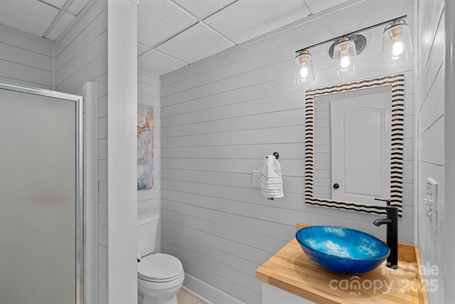 1317 Longleaf Ct, Matthews, NC 28104 - full bathroom featuring a stall shower, wood walls, and vanity