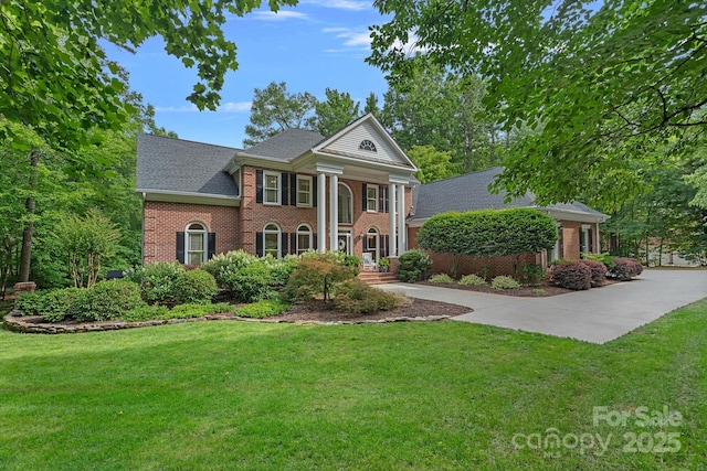 1317 Longleaf Ct, Matthews, NC 28104 - greek revival inspired property with brick siding, a front lawn, and roof with shingles