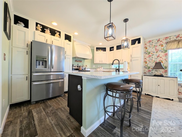 4713 White Store Rd, Wingate, NC 28174 - kitchen with stainless steel refrigerator with ice dispenser, dark wood-style flooring, white cabinets, decorative light fixtures, and a breakfast bar area