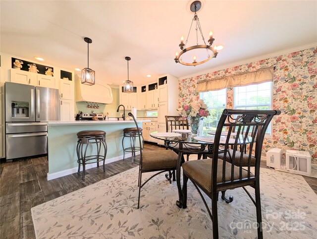 4713 White Store Rd, Wingate, NC 28174 - dining space featuring dark wood finished floors, a chandelier, crown molding, and wallpapered walls