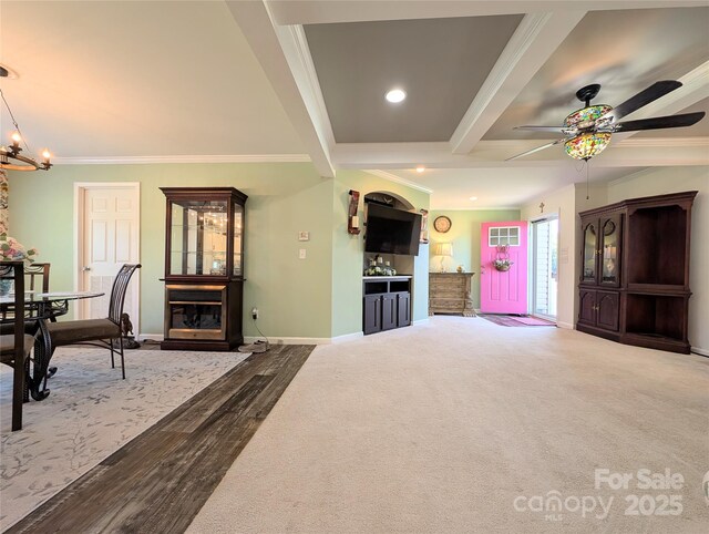 4713 White Store Rd, Wingate, NC 28174 - living area with ornamental molding, ceiling fan, a chandelier, beam ceiling, and a fireplace