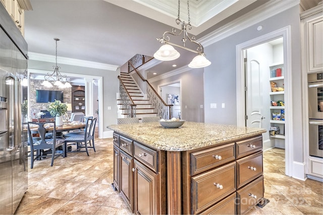 6216 N Rd, York, SC 29745 - kitchen featuring ornamental molding, decorative light fixtures, light stone counters, a center island, and a chandelier