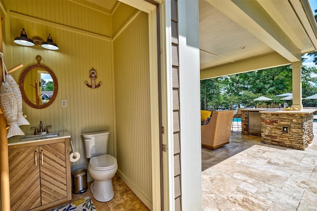 6216 N Rd, York, SC 29745 - bathroom with vanity, stone tile floors, and wooden walls