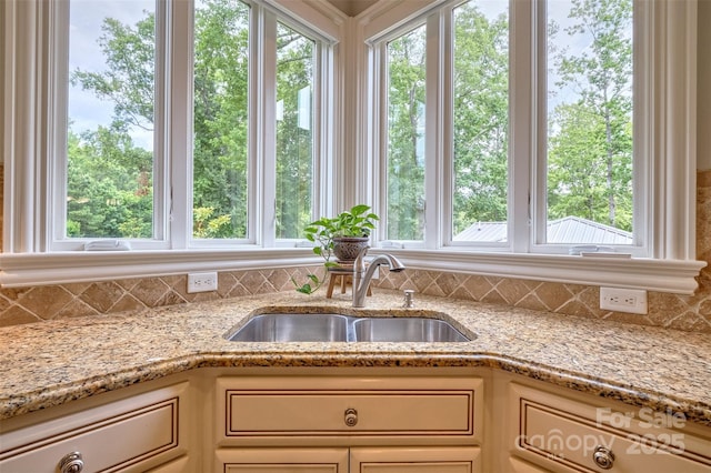 6216 N Rd, York, SC 29745 - kitchen with decorative backsplash, light stone countertops, and cream cabinetry
