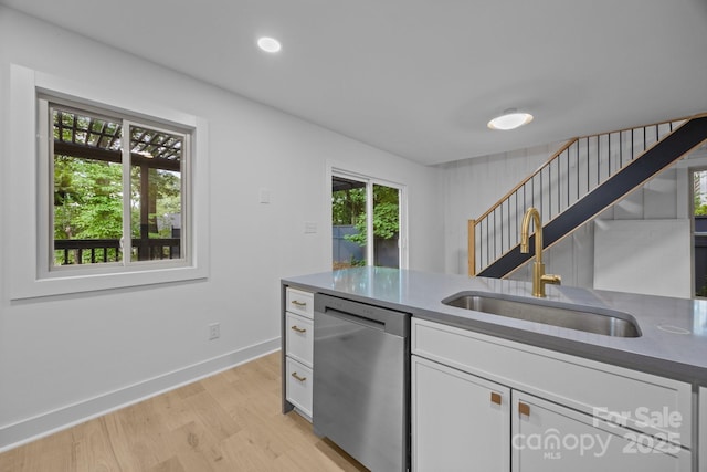 6501 Piney Path Rd, Charlotte, NC 28212 - kitchen with stainless steel dishwasher, light wood-style floors, white cabinets, dark countertops, and recessed lighting