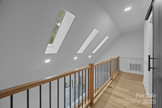 6501 Piney Path Rd, Charlotte, NC 28212 - hall featuring a skylight, light wood-style flooring, vaulted ceiling, and recessed lighting