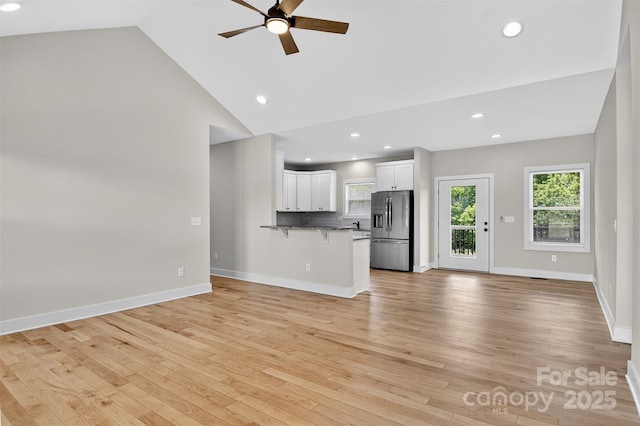 1019 Null Rd, Lincolnton, NC 28092 - unfurnished living room with ceiling fan, light wood-style flooring, recessed lighting, and high vaulted ceiling