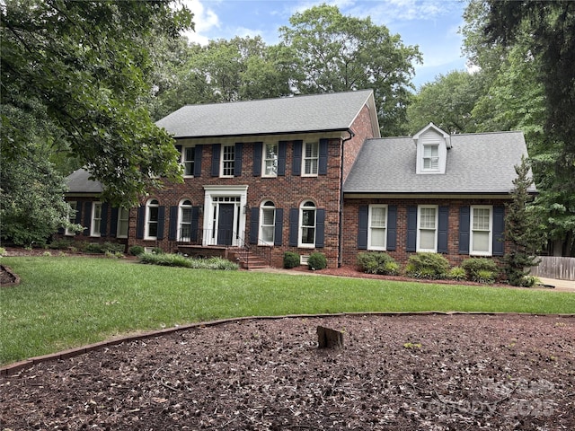 1545 Chadmore Ln NW, Concord, NC 28027 - view of front facade with brick siding, a front lawn, and a shingled roof