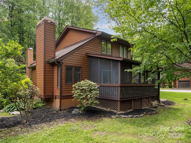 107 N Garden Ct, Fletcher, NC 28732 - back of house featuring a chimney, a sunroom, and a lawn
