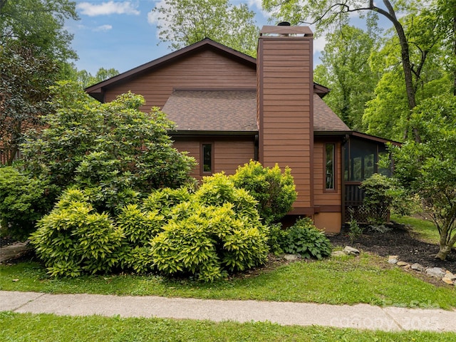 107 N Garden Ct, Fletcher, NC 28732 - view of side of property featuring a chimney, roof with shingles, and a sunroom