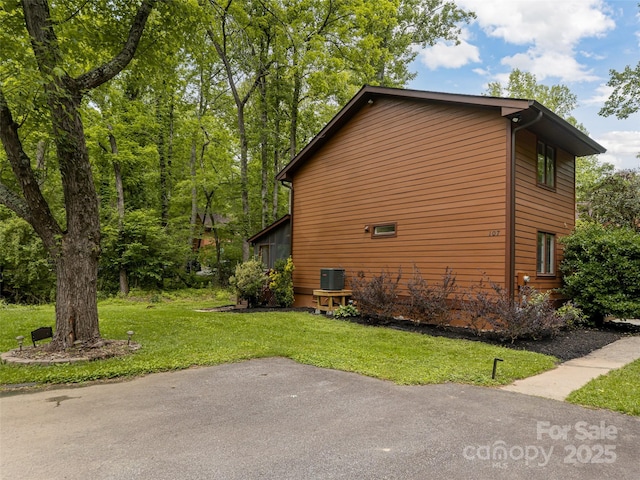 107 N Garden Ct, Fletcher, NC 28732 - view of side of property featuring a yard and a central air condition unit
