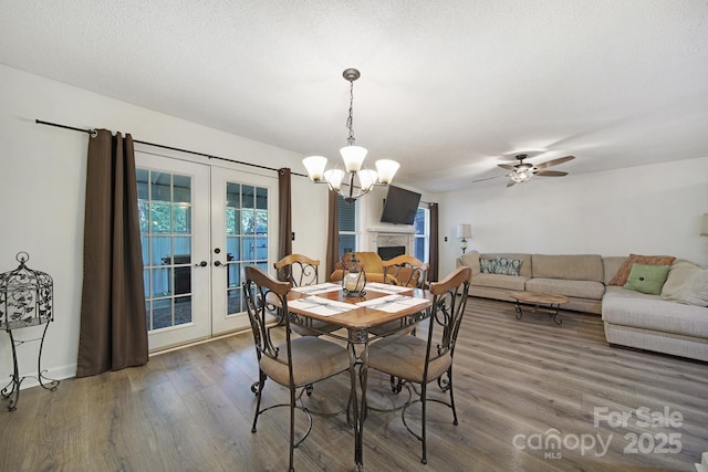 1003 Cranberry Cir, Fort Mill, SC 29715 - dining space featuring french doors, wood finished floors, a chandelier, and a ceiling fan