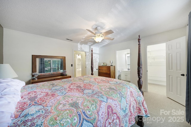1003 Cranberry Cir, Fort Mill, SC 29715 - bedroom with ensuite bathroom, a walk in closet, light colored carpet, ceiling fan, and a textured ceiling