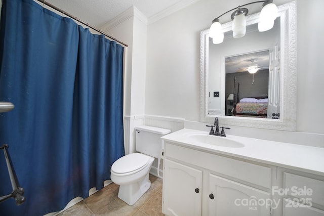 1003 Cranberry Cir, Fort Mill, SC 29715 - ensuite bathroom featuring ornamental molding, vanity, wainscoting, tile patterned floors, and a ceiling fan