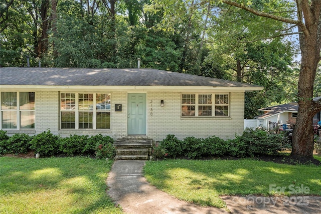 3130 Erskine Dr, Charlotte, NC 28205 - ranch-style house with brick siding, a front lawn, and a shingled roof