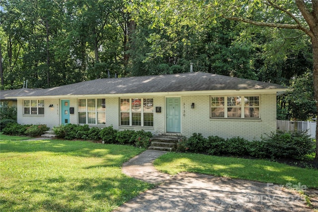 3130 Erskine Dr, Charlotte, NC 28205 - view of front of property with brick siding, a front lawn, and a shingled roof