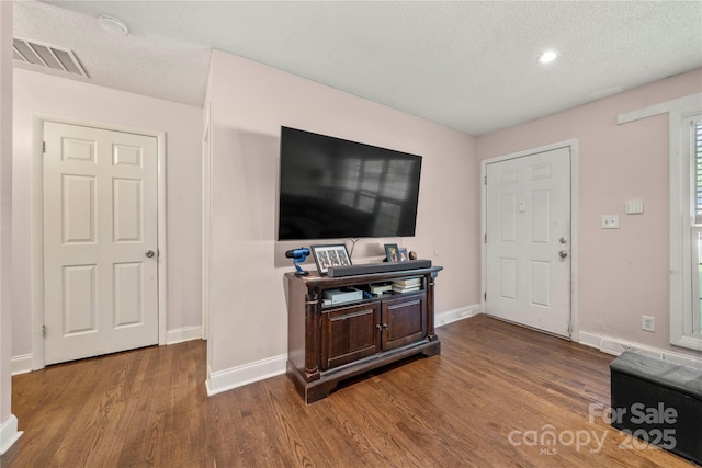 3130 Erskine Dr, Charlotte, NC 28205 - living room featuring wood finished floors, a textured ceiling, and recessed lighting