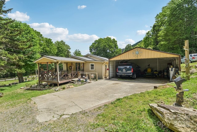 19 Lockman Rd, Maggie Valley, NC 28751 - view of front of home with covered porch, a carport, concrete driveway, and a front lawn