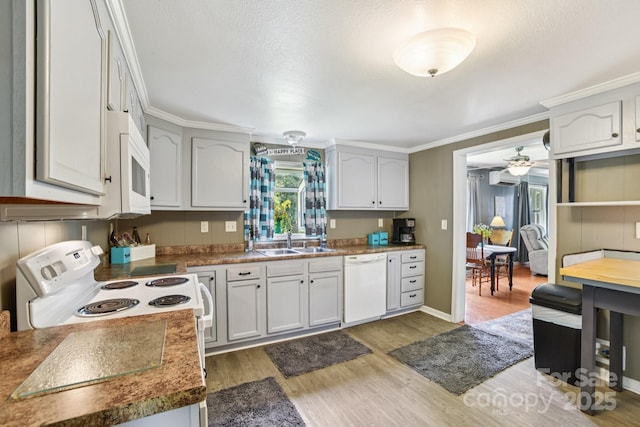 19 Lockman Rd, Maggie Valley, NC 28751 - kitchen with white appliances, light wood-style floors, crown molding, a ceiling fan, and a wall unit AC