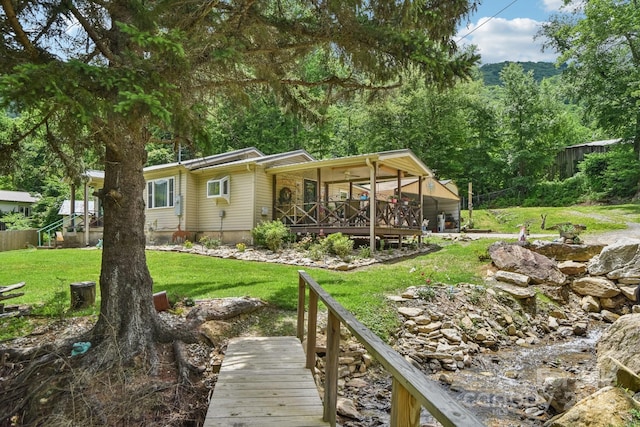 19 Lockman Rd, Maggie Valley, NC 28751 - back of house with a lawn and a view of trees