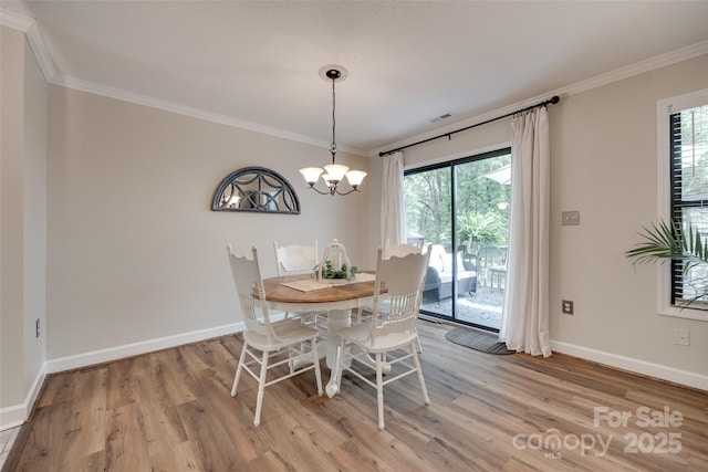 353 Tall Oaks Trl, Fort Mill, SC 29715 - dining area with light wood-type flooring, ornamental molding, healthy amount of natural light, and a chandelier