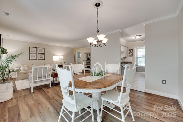 353 Tall Oaks Trl, Fort Mill, SC 29715 - dining space with ornamental molding, a chandelier, and light wood-style floors