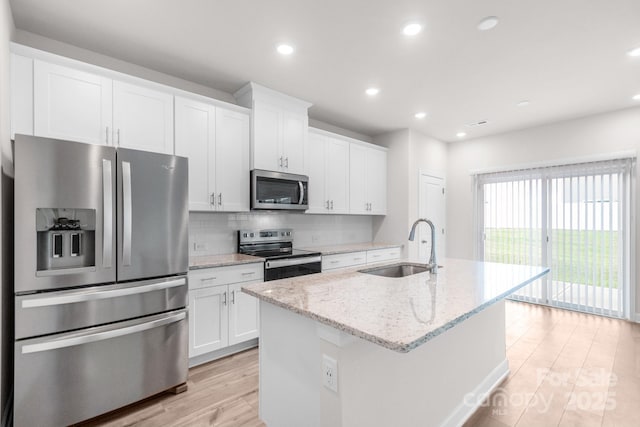1022 Jeffery Dean Ct, Albemarle, NC 28001 - kitchen featuring stainless steel appliances, light wood-style floors, a kitchen island with sink, white cabinets, and recessed lighting