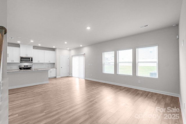 1022 Jeffery Dean Ct, Albemarle, NC 28001 - unfurnished living room featuring light wood-style floors and recessed lighting
