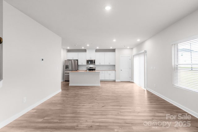 1022 Jeffery Dean Ct, Albemarle, NC 28001 - unfurnished living room with light wood-style flooring and recessed lighting