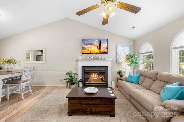 2490 Hawk Ridge Dr, Gastonia, NC 28056 - living area featuring lofted ceiling, wood finished floors, ceiling fan, and a glass covered fireplace