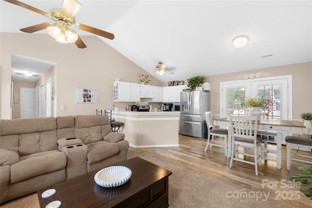 2490 Hawk Ridge Dr, Gastonia, NC 28056 - living area featuring a ceiling fan, high vaulted ceiling, light carpet, and light wood finished floors