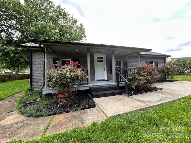 111 Rose St, Mount Holly, NC 28120 - view of front of house featuring covered porch and a metal roof
