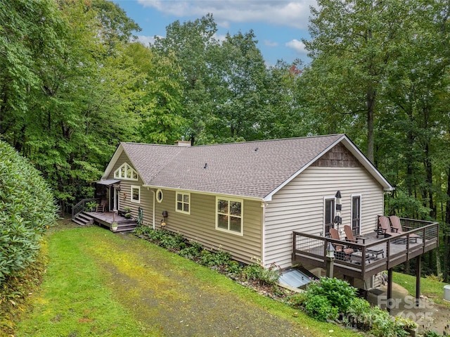 21 Fern Haven Ln, Fairview, NC 28730 - back of property featuring a wooden deck, roof with shingles, a yard, and a chimney