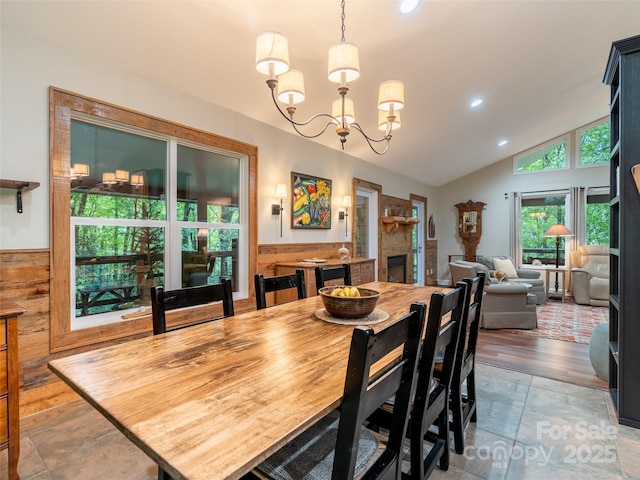 21 Fern Haven Ln, Fairview, NC 28730 - dining room with vaulted ceiling, recessed lighting, a chandelier, a fireplace, and stone tile flooring
