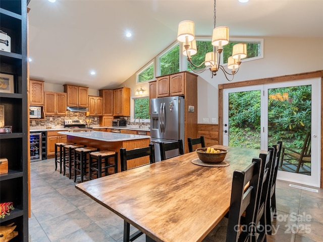 21 Fern Haven Ln, Fairview, NC 28730 - dining space with beverage cooler, a chandelier, high vaulted ceiling, and recessed lighting