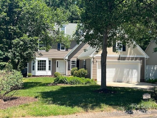 11021 Scrimshaw Ln, Charlotte, NC 28215 - view of front of property featuring a front lawn, an attached garage, and driveway