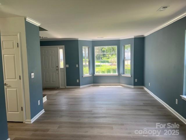 11021 Scrimshaw Ln, Charlotte, NC 28215 - foyer with crown molding and wood finished floors