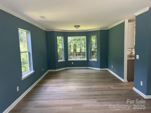 11021 Scrimshaw Ln, Charlotte, NC 28215 - spare room with crown molding and wood finished floors