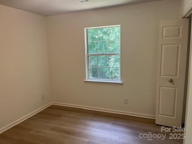 11021 Scrimshaw Ln, Charlotte, NC 28215 - spare room featuring wood finished floors and baseboards