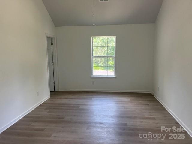 11021 Scrimshaw Ln, Charlotte, NC 28215 - unfurnished room featuring vaulted ceiling and wood finished floors