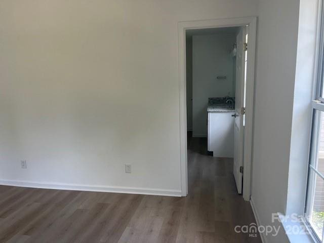 11021 Scrimshaw Ln, Charlotte, NC 28215 - corridor with dark wood finished floors and baseboards