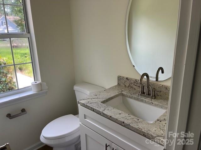11021 Scrimshaw Ln, Charlotte, NC 28215 - half bathroom with healthy amount of natural light and vanity