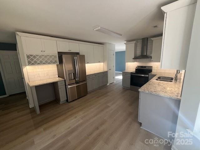 11021 Scrimshaw Ln, Charlotte, NC 28215 - kitchen with wall chimney exhaust hood, stainless steel appliances, tasteful backsplash, and wood finished floors