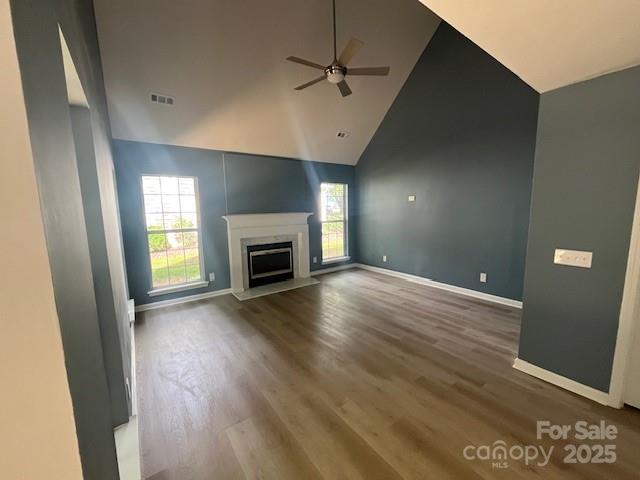 11021 Scrimshaw Ln, Charlotte, NC 28215 - unfurnished living room with a ceiling fan, wood finished floors, a fireplace, and high vaulted ceiling