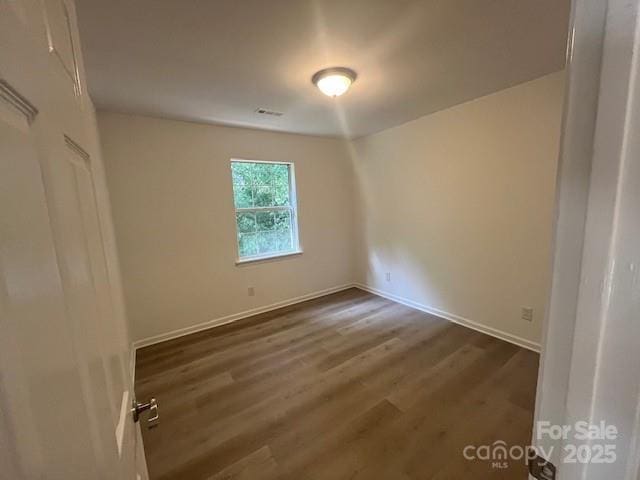 11021 Scrimshaw Ln, Charlotte, NC 28215 - spare room with wood finished floors and baseboards