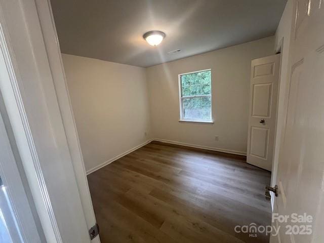 11021 Scrimshaw Ln, Charlotte, NC 28215 - empty room with wood finished floors and baseboards