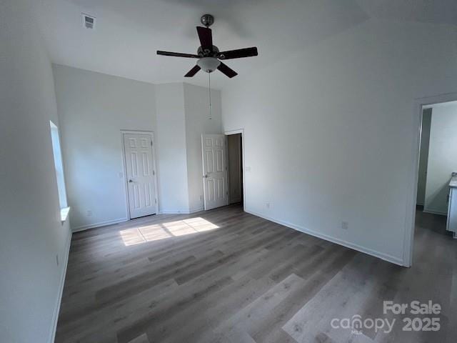 11021 Scrimshaw Ln, Charlotte, NC 28215 - unfurnished bedroom with high vaulted ceiling, wood finished floors, and a ceiling fan