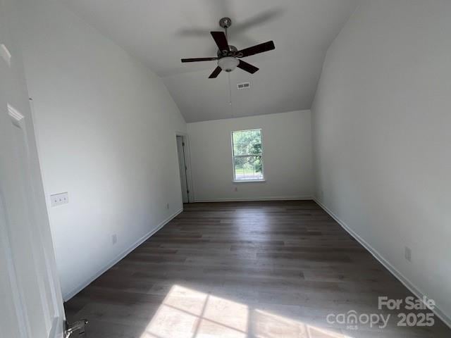 11021 Scrimshaw Ln, Charlotte, NC 28215 - spare room featuring vaulted ceiling, wood finished floors, and ceiling fan
