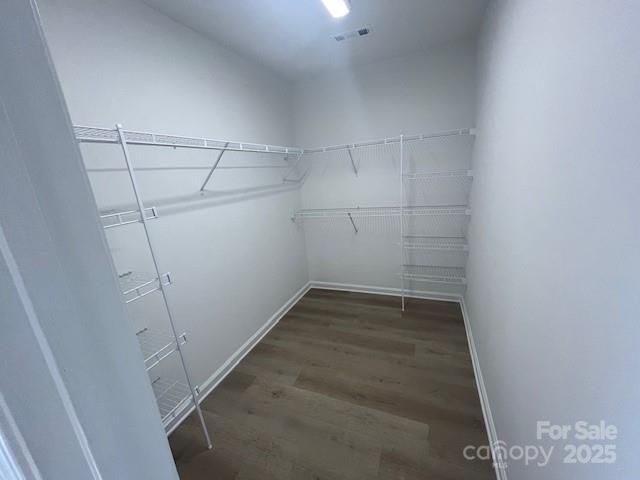 11021 Scrimshaw Ln, Charlotte, NC 28215 - walk in closet featuring wood finished floors